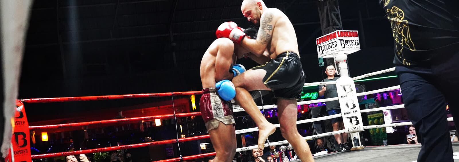 A Muay Thai bout in the ring at Loi Kroh Boxing Stadium
